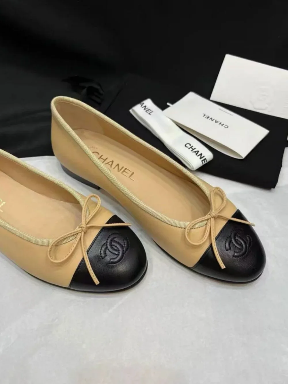 CHANEL Two‑Tone Bow‑Trim Leather Round‑Toe Ballet Flats
